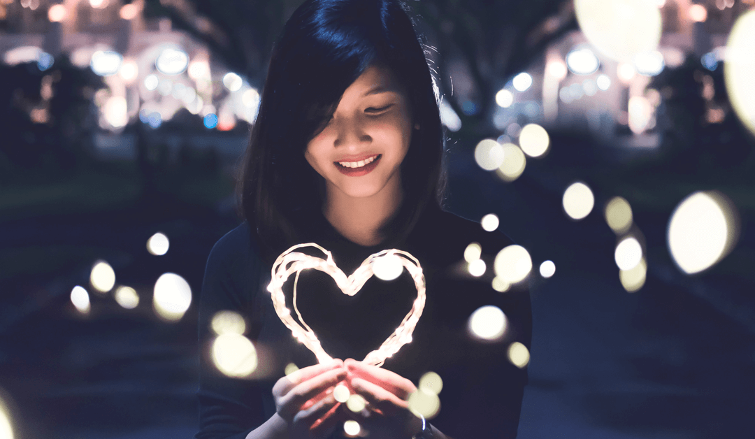 woman holding a heart of light